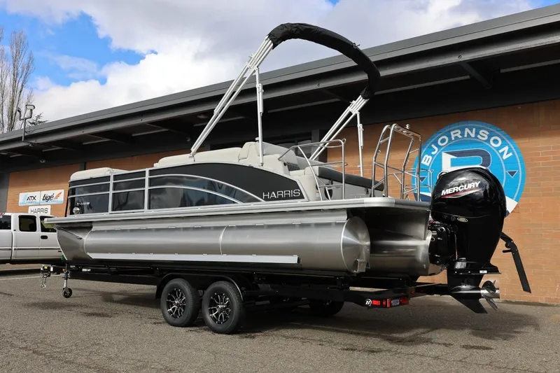 Slide: The Image of 2026 Harris Cruiser 210 SL pontoon boat on trailer, featuring Mercury outboard motor. - 4