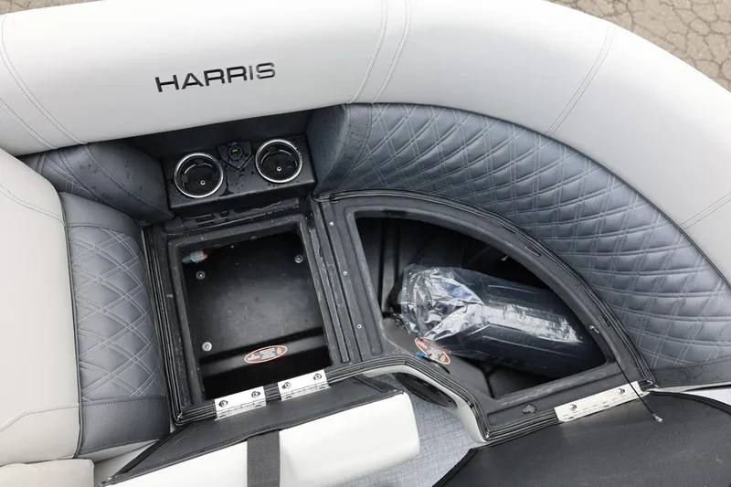 Slide: The Image of 2026 Harris Cruiser 210 SL boat interior with storage compartments and cup holders. - 40