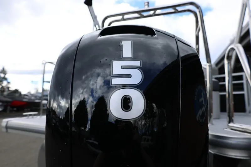 Slide: The Image of Close-up of a 2026 Harris Cruiser 210 SL boat engine with "150" marking. - 43