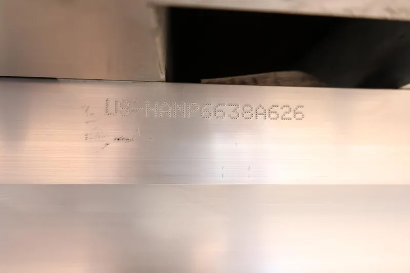 Slide: The Image of 2026 Harris Cruiser 210 SL hull identification number engraved on metal surface. - 9