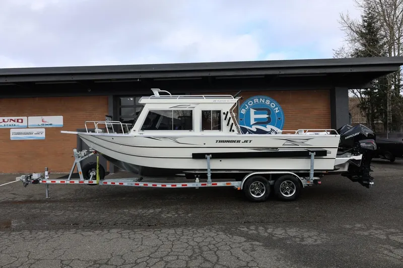 Slide: The Image of 2026 Thunder Jet 26 Alexis Pro XL boat on trailer outside dealership. - 1