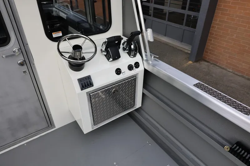 Slide: The Image of Interior helm of 2026 Thunder Jet 26 Alexis Pro XL boat, featuring steering wheel and controls. - 18