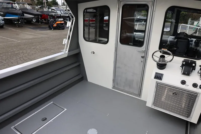 Slide: The Image of Interior view of 2026 Thunder Jet 26 Alexis Pro XL boat, featuring helm and seating area. - 19