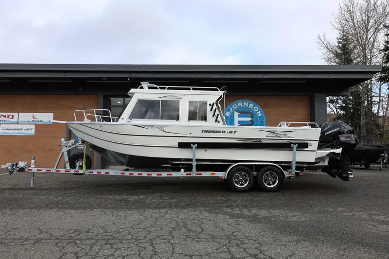 Slide: The Image of 2026 Thunder Jet 26 Alexis Pro XL boat on trailer outside dealership. - 2