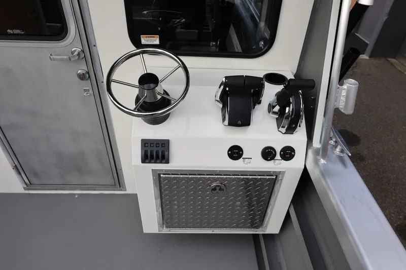 Slide: The Image of Control panel of 2026 Thunder Jet 26 Alexis Pro XL boat, featuring steering wheel and throttle controls. - 25