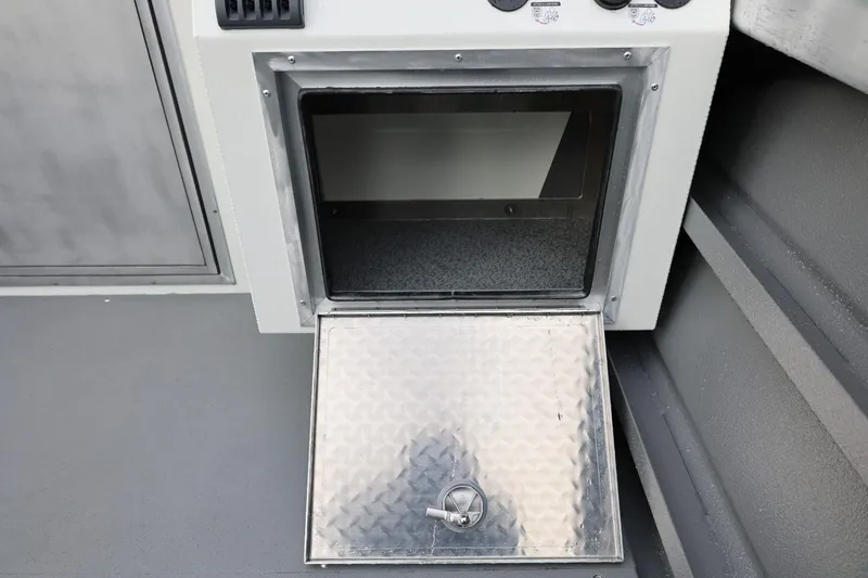 Slide: The Image of Open storage compartment on 2026 Thunder Jet 26 Alexis Pro XL boat. - 27