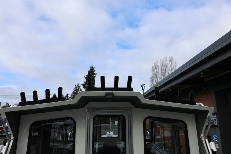 Slide: The Image of 2026 Thunder Jet 26 Alexis Pro XL boat with rod holders against cloudy sky. - 28