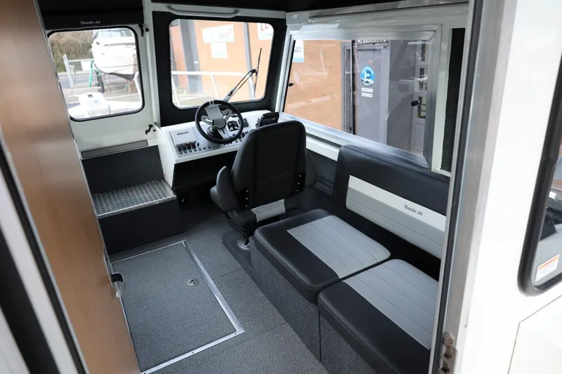 Slide: The Image of Interior of 2026 Thunder Jet 26 Alexis Pro XL boat, featuring seating and steering area. - 29