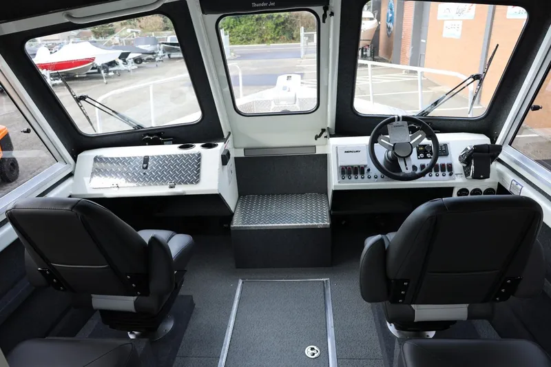 Slide: The Image of Interior of 2026 Thunder Jet 26 Alexis Pro XL boat, featuring modern controls and seating. - 30