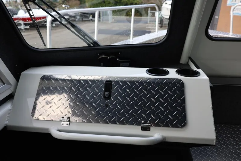 Slide: The Image of Interior of 2026 Thunder Jet 26 Alexis Pro XL boat with diamond plate panel and cup holders. - 37