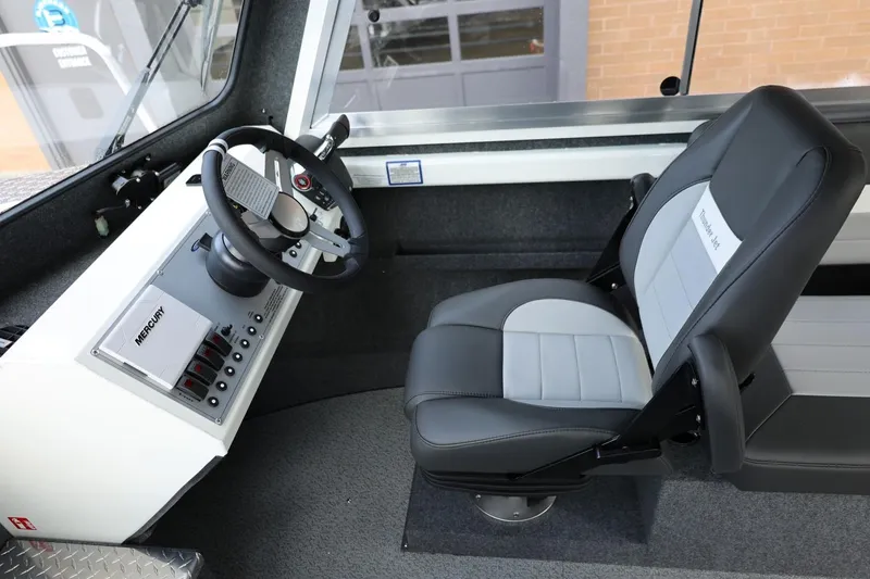 Slide: The Image of Interior of 2026 Thunder Jet 26 Alexis Pro XL boat, featuring steering wheel and captain's chair. - 48