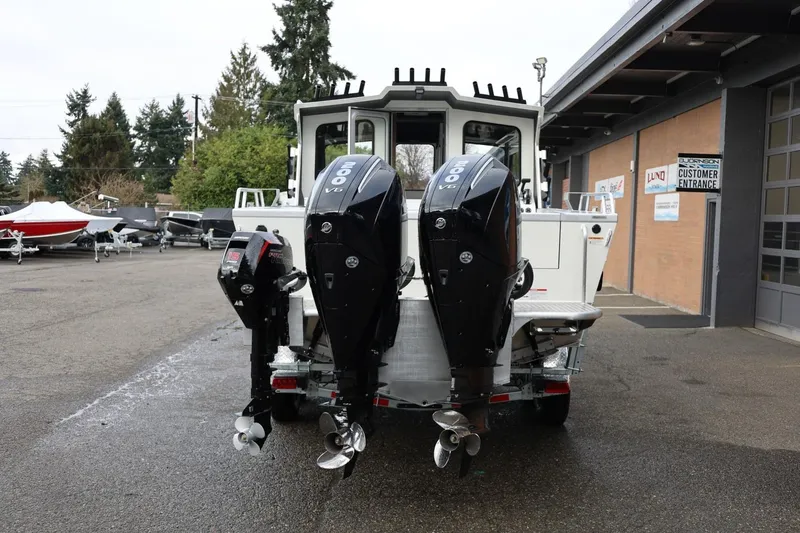 Slide: The Image of 2026 Thunder Jet 26 Alexis Pro XL with dual outboard motors in a dealership lot. - 5