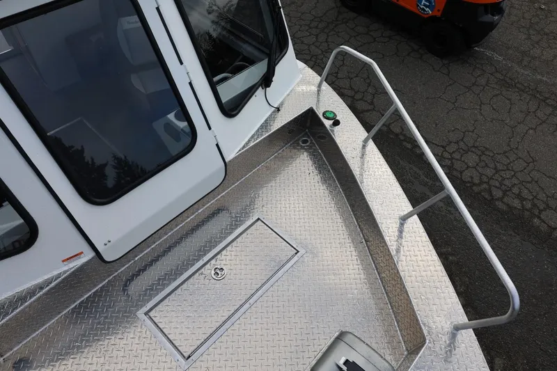 Slide: The Image of 2026 Thunder Jet 26 Alexis Pro XL boat deck with diamond plate flooring and railing. - 56