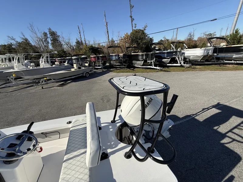 Slide: The Image of Xplor Delta 18CC GUIDE SERIES 2026 boat with Yamaha engine in parking lot. - 10