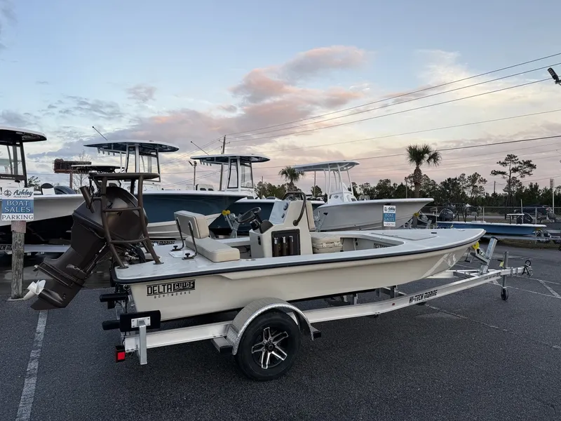 Slide: The Image of 2026 Xplor Delta 18CC GUIDE SERIES boat on trailer at sunset. - 3