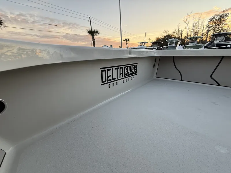 Slide: The Image of Xplor Delta 18CC GUIDE SERIES 2026 boat at sunset. - 4