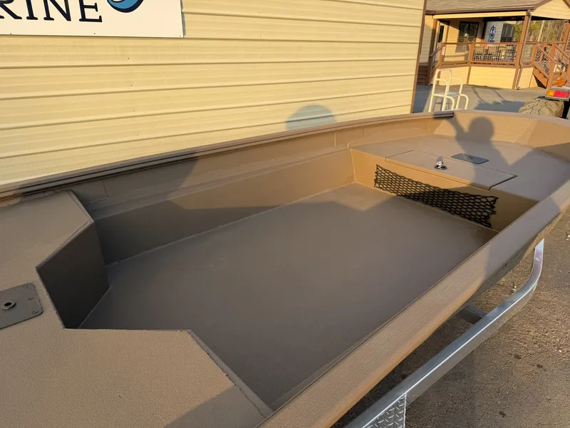 Slide: The Image of Interior of Xpress HD16DBX boat, 2026 model, on a trailer. - 12