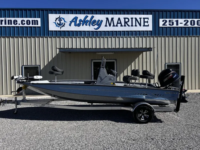 Slide: The Image of 2026 Xpress H20B Bay boat in front of Ashley Marine building. - 1