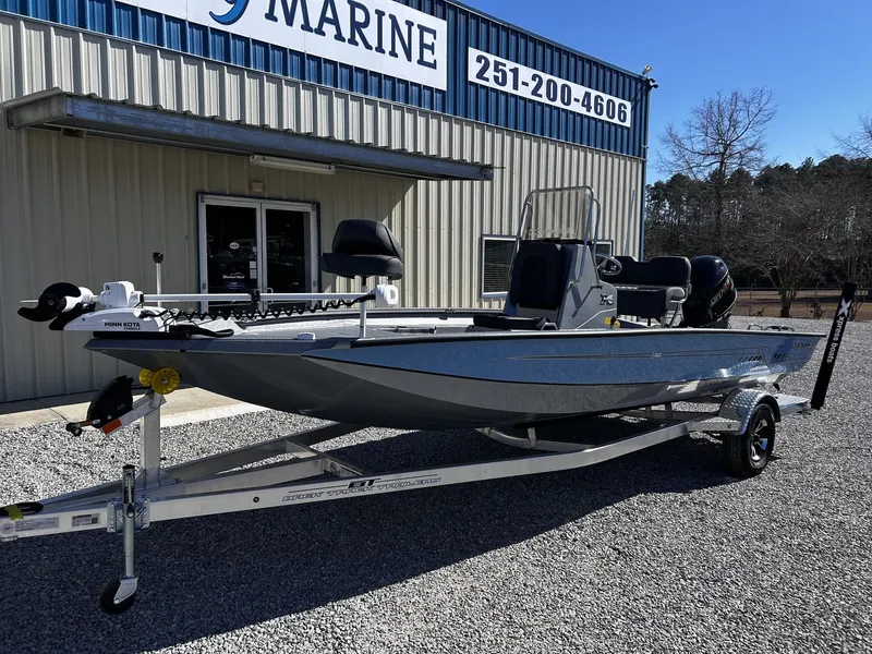 Slide: The Image of 2026 Xpress H20B Bay boat in front of a marine shop. - 6