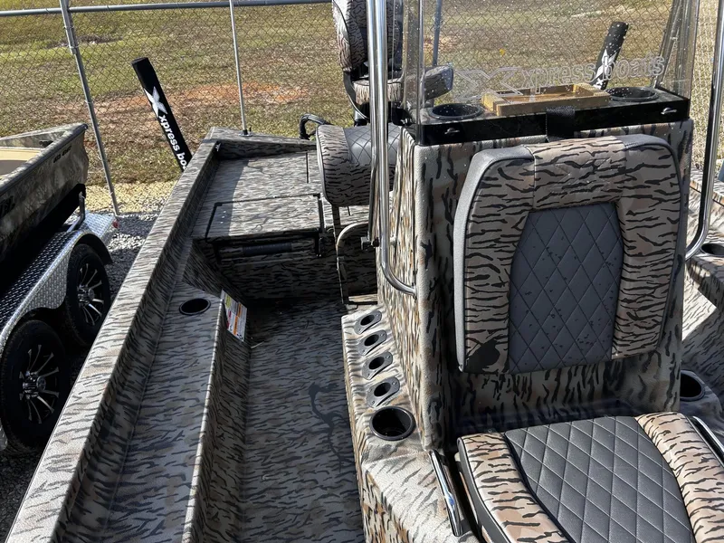 Slide: The Image of 2026 Xpress H20B Bay boat with camouflage pattern and cushioned seats. - 13