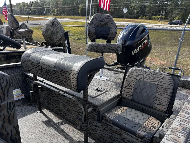 Slide: The Image of 2026 Xpress H20B Bay boat with camouflage pattern and motor. - 8