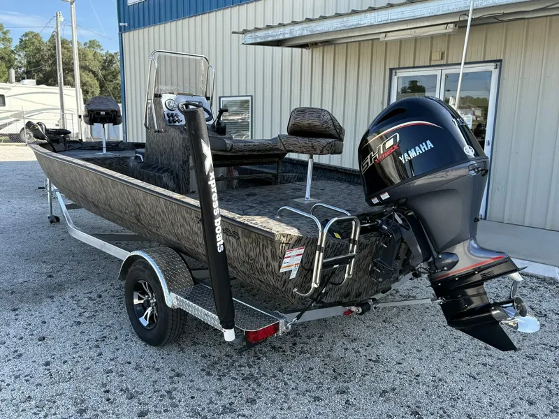 Slide: The Image of 2026 Xpress H20B Bay boat with Yamaha engine on trailer. - 5