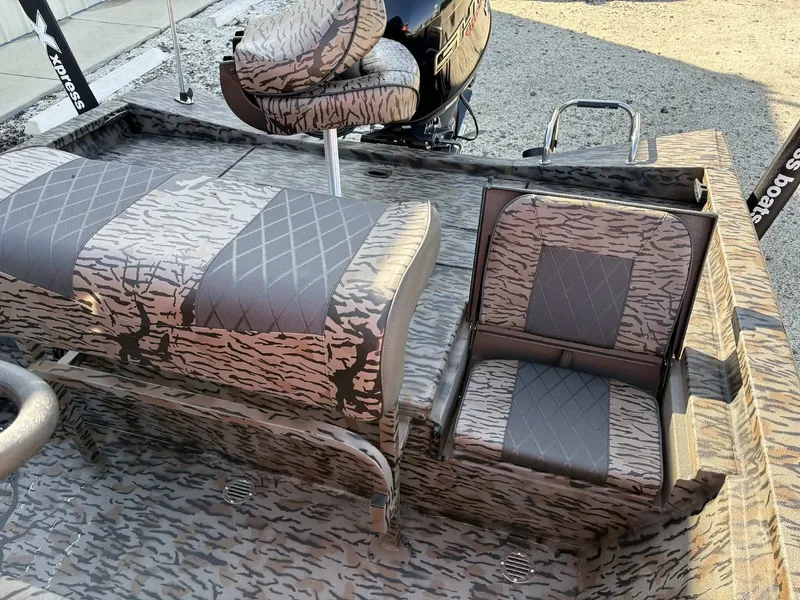 Slide: The Image of 2026 Xpress H20B Bay boat with camouflage-patterned seats. - 9