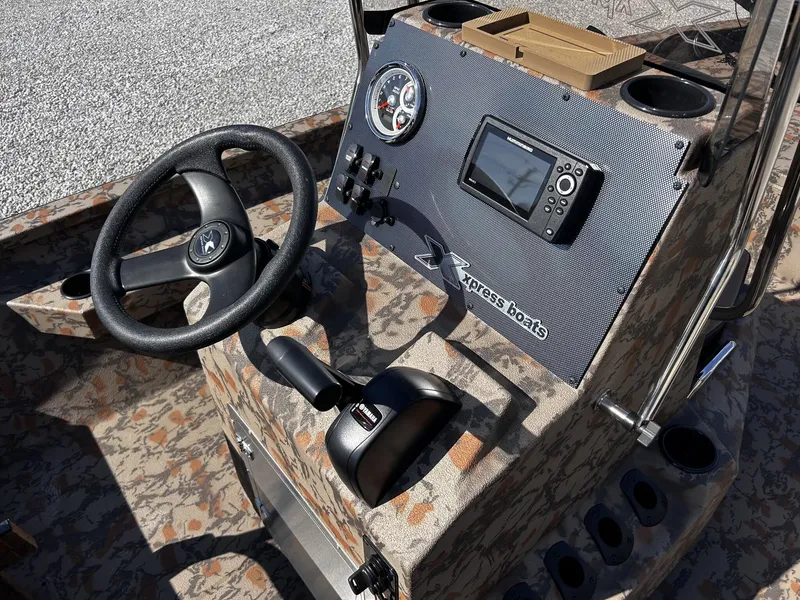 Slide: The Image of 2026 Xpress H20B Bay boat console with steering and instruments. - 4