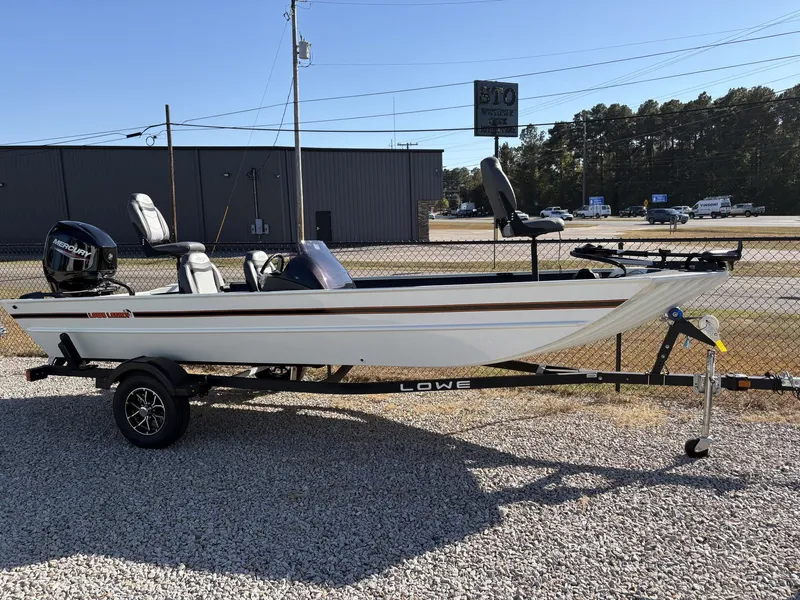 Slide: The Image of 2026 Xpress H20B Bay boat on trailer, side view. - 1