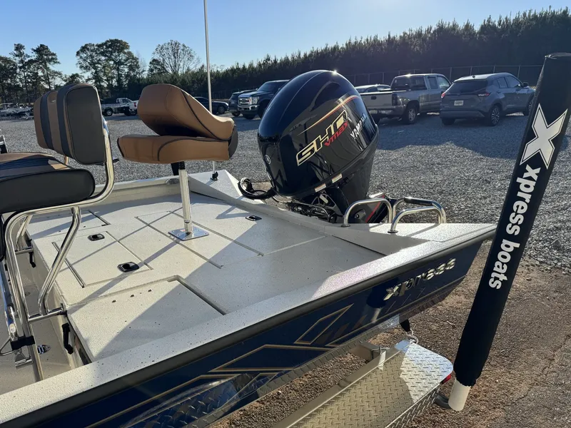Slide: The Image of 2026 Xpress H20B Bay boat with Yamaha engine outdoors. - 9