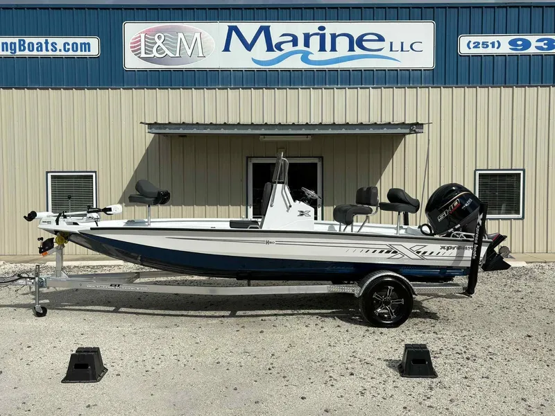 Slide: The Image of 2026 Xpress H20B Bay boat in front of L&M Marine building. - 1