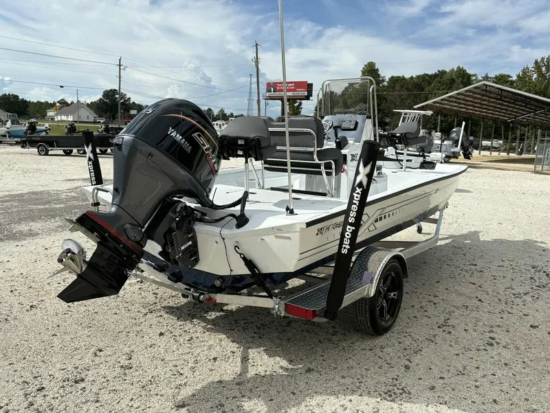 Slide: The Image of 2026 Xpress H20B Bay boat with outboard motor on trailer. - 7
