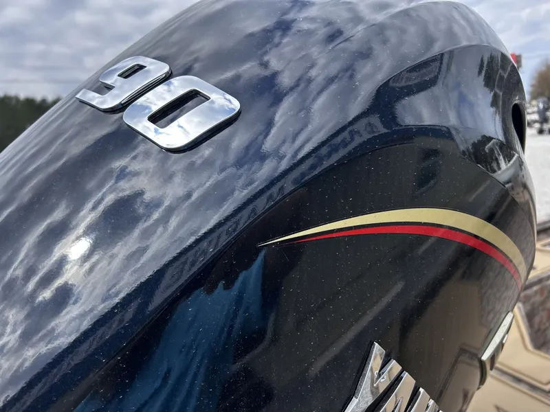 Slide: The Image of Close-up of a shiny 90 HP boat outboard motor. - 12