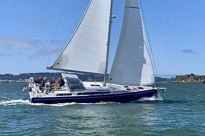 Slide: The Image of 2022 Beneteau Oceanis Yacht 54 sailing on open water under clear skies. - 0