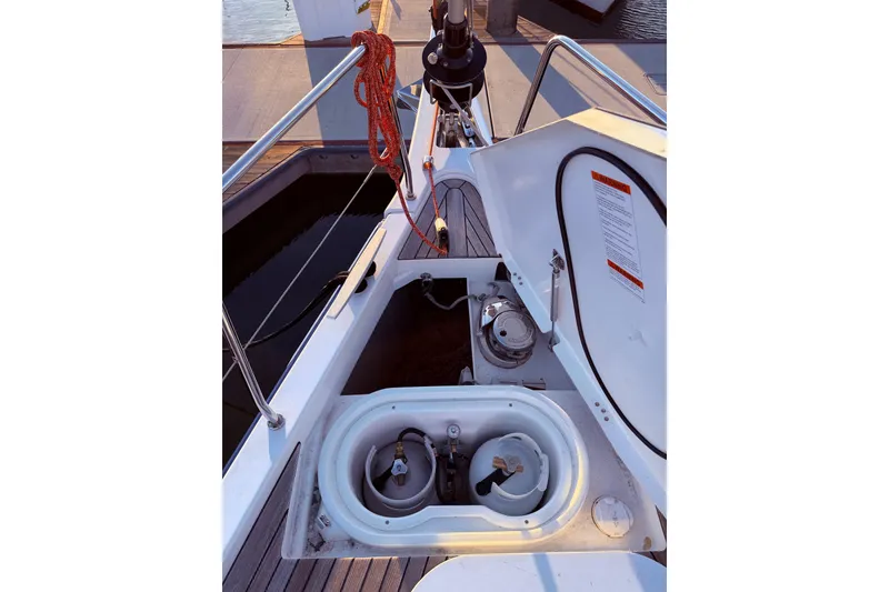 Slide: The Image of Beneteau Oceanis Yacht 54 (2022) deck view with open storage compartment. - 11