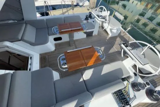 Slide: The Image of Luxurious 2022 Beneteau Oceanis Yacht 54 cockpit with dual helm and teak seating. - 12