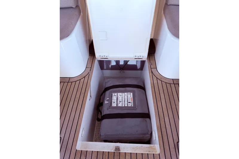 Slide: The Image of Storage compartment on 2022 Beneteau Oceanis Yacht 54 with safety equipment. - 22