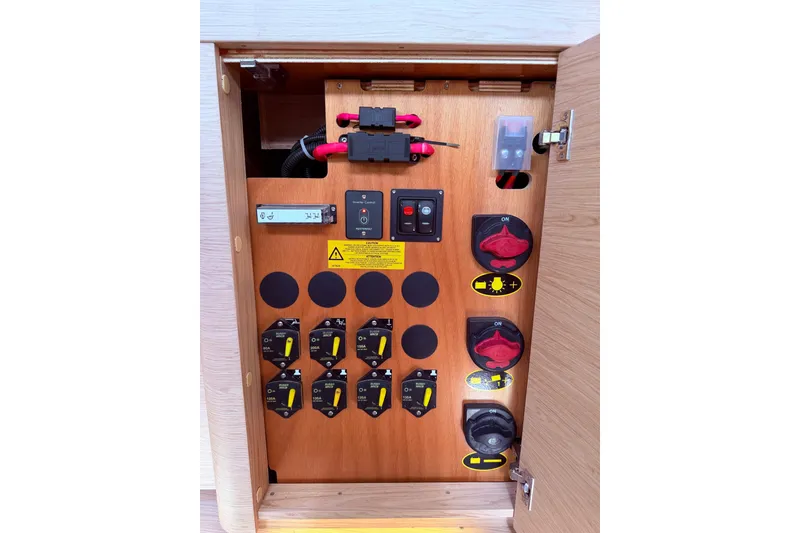 Slide: The Image of Electrical panel inside 2022 Beneteau Oceanis Yacht 54, featuring switches and controls. - 57