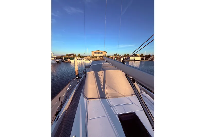 Slide: The Image of Beneteau Oceanis Yacht 54, 2022 model, docked at marina during sunset. - 8