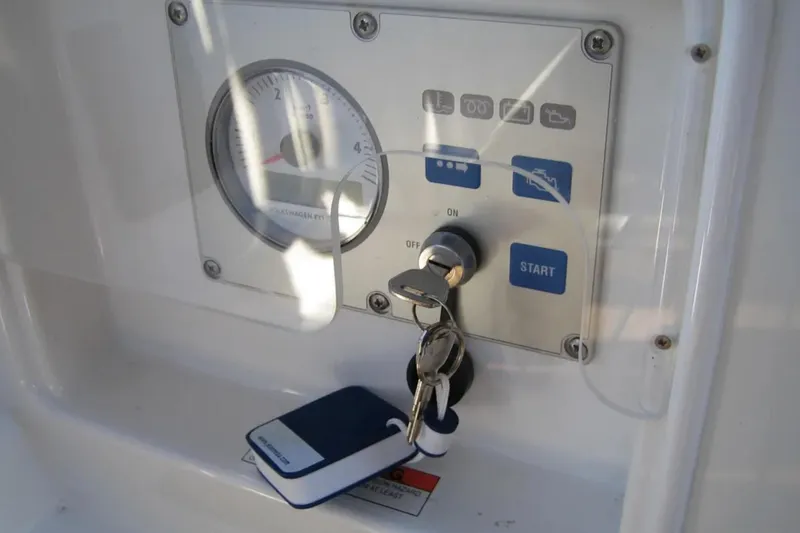 Slide: The Image of Control panel with keys for a 2011 Jeanneau 57 yacht, featuring start button and gauge. - 11