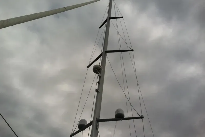 Slide: The Image of Mast of 2011 Jeanneau 57 sailboat against cloudy sky. - 13