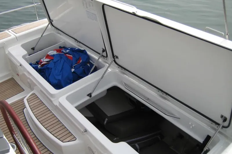 Slide: The Image of Open storage compartments on a 2011 Jeanneau 57 yacht deck, containing sailing gear. - 16