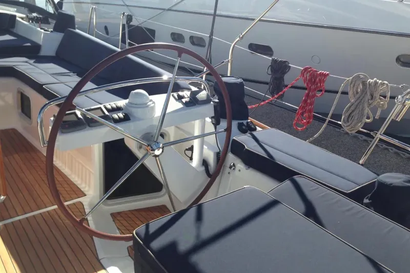 Slide: The Image of Steering wheel and seating area of a 2011 Jeanneau 57 yacht with wooden deck. - 18