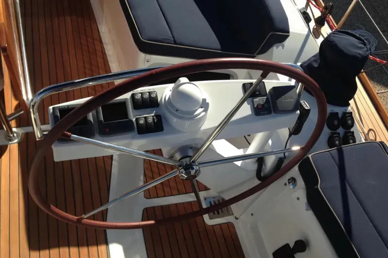Slide: The Image of Steering wheel and controls of 2011 Jeanneau 57 yacht on teak deck. - 19