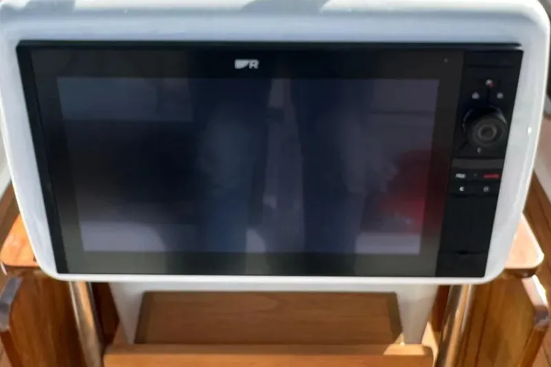 Slide: The Image of Navigation display on a 2011 Jeanneau 57 yacht, featuring control buttons and a screen. - 22