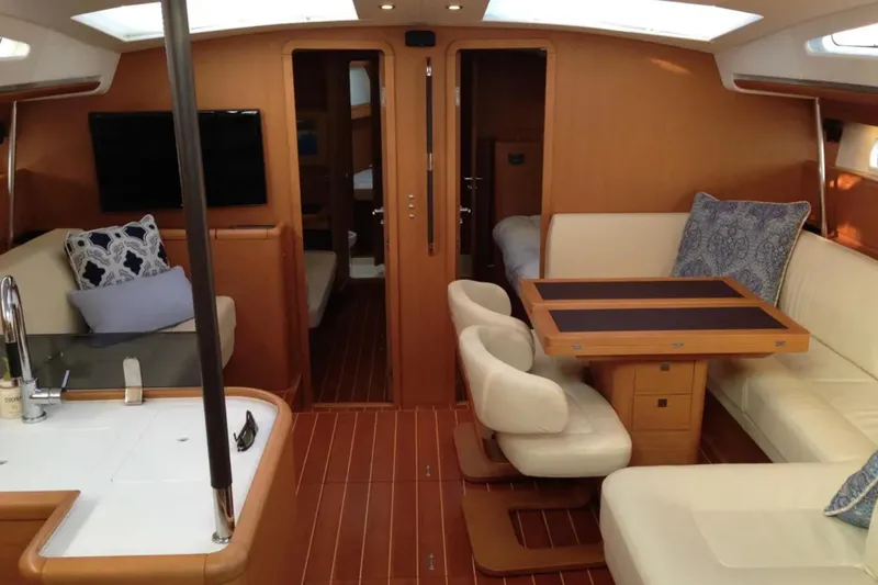 Slide: The Image of Luxurious interior of a 2011 Jeanneau 57 yacht with elegant seating and wooden finishes. - 24