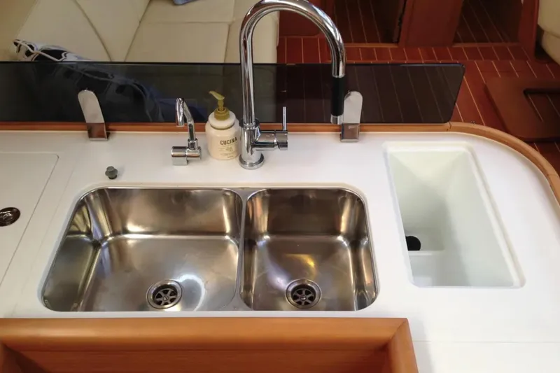 Slide: The Image of Luxury Jeanneau 57 yacht kitchen sink with dual basins, faucet, and soap dispenser, 2011 model. - 34