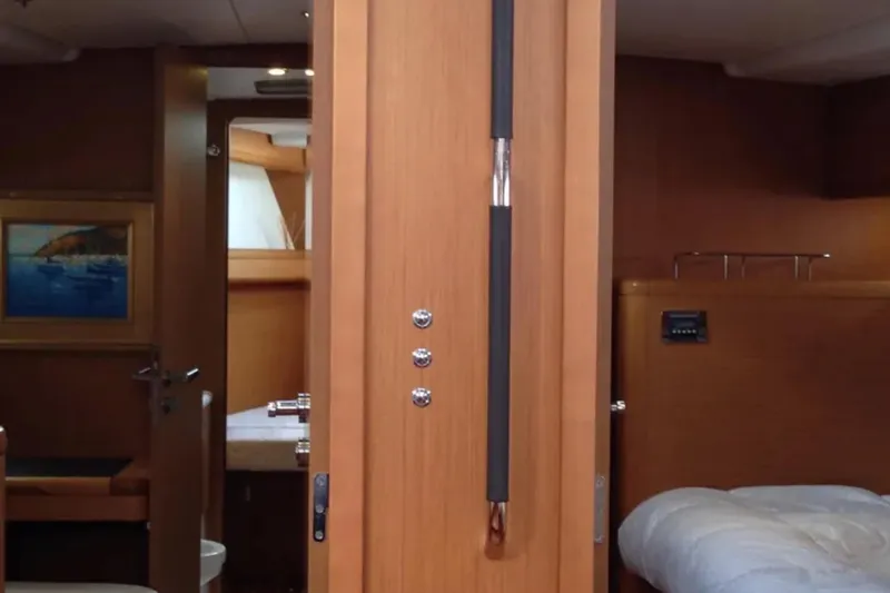 Slide: The Image of Interior of 2011 Jeanneau 57 yacht, featuring wooden cabinetry and cozy sleeping quarters. - 39