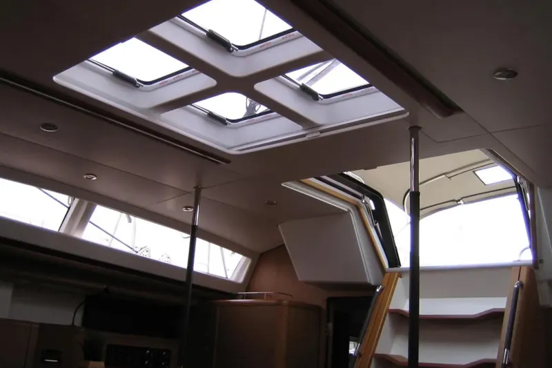 Slide: The Image of Interior view of 2011 Jeanneau 57 yacht, featuring skylights and wooden stairs. - 45