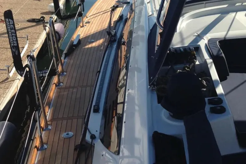 Slide: The Image of 2011 Jeanneau 57 sailboat deck with wooden finish and sleek design. - 7